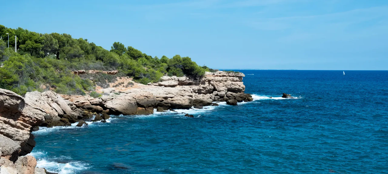 Aerial view of L&rsquo;Ametlla de Mar, with its crystal-clear waters and lush natural setting, perfect for diving.